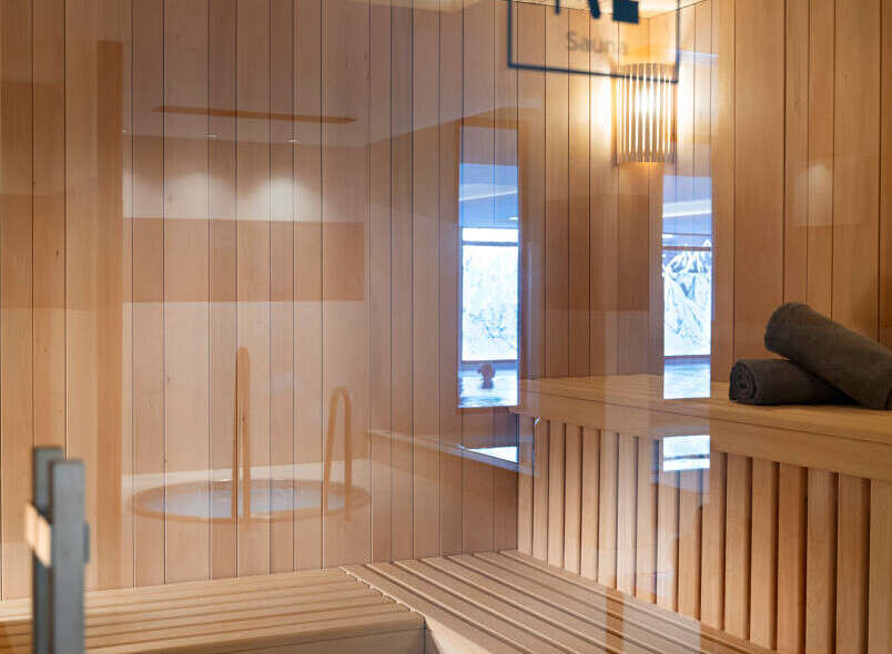 Relax and rejuvenate in our luxurious sauna, featuring a spacious wooden interior, comfortable benches, and a calming atmosphere.