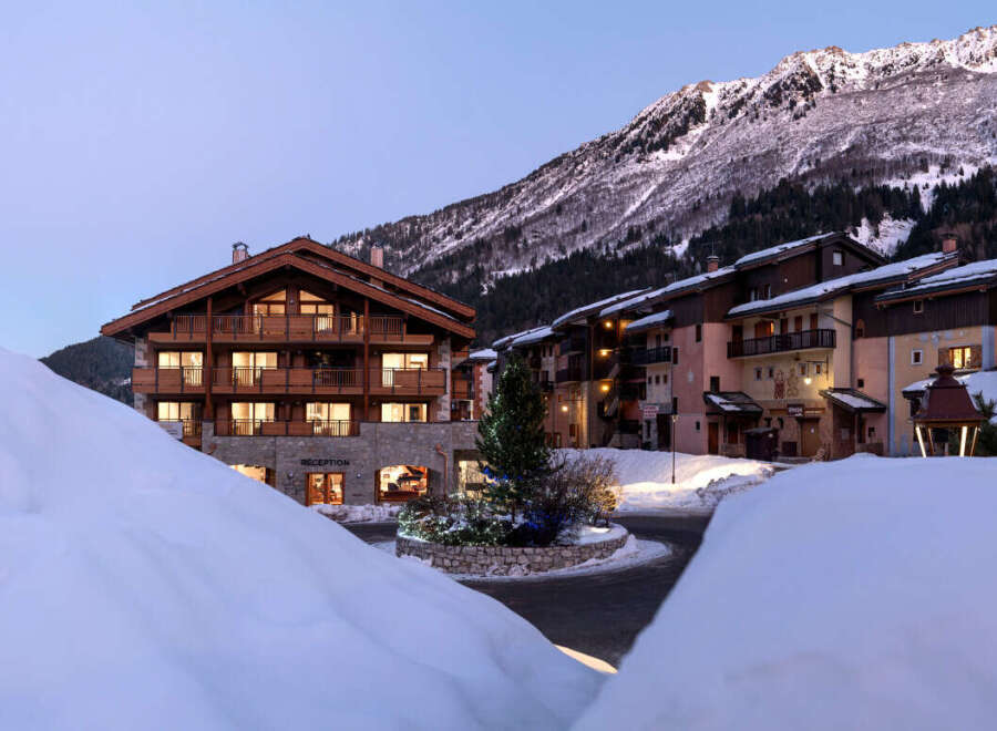 Nestled in a snow-covered mountain village, this stunning chalet-style hotel offers breathtaking views and luxurious accommodations.