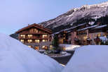Nestled in a snow-covered mountain village, this stunning chalet-style hotel offers breathtaking views and luxurious accommodations.