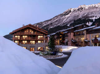 Nestled in a snow-covered mountain village, this stunning chalet-style hotel offers breathtaking views and luxurious accommodations.