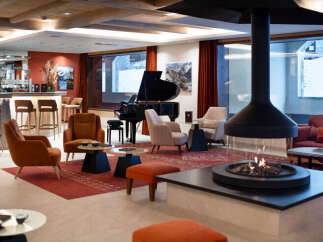 Relax in style in our luxurious hotel lobby, featuring a cozy fireplace, comfortable seating, and a fully-stocked bar.