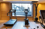 This stunning gym boasts state-of-the-art Technogym equipment, including treadmills and ellipticals, all while offering breathtaking views through large windows.