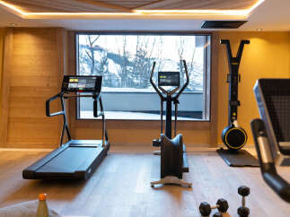 This stunning gym boasts state-of-the-art Technogym equipment, including treadmills and ellipticals, all while offering breathtaking views through large windows.