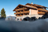 This stunning chalet-style hotel boasts multiple floors with private balconies, offering breathtaking mountain views.