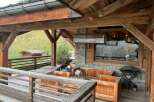 This stunning chalet boasts a spacious outdoor deck with breathtaking mountain views, perfect for relaxing and enjoying the fresh air.