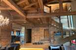 This stunning chalet boasts a magnificent open-plan living area with exposed wooden beams and a breathtaking wooden staircase.