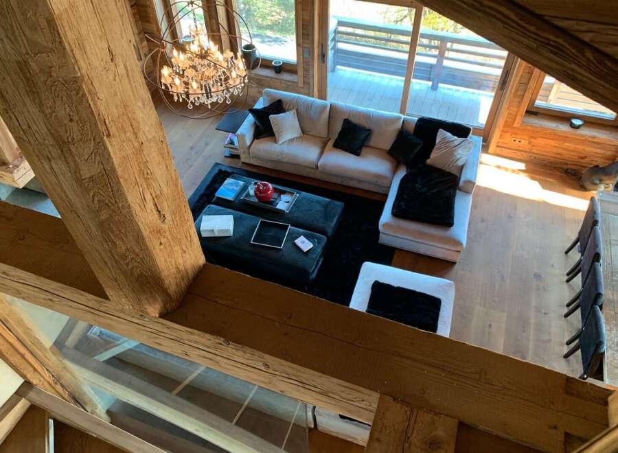 Luxurious chalet with stunning wooden beams and large windows offering breathtaking views.