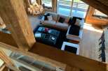 Luxurious chalet with stunning wooden beams and large windows offering breathtaking views.