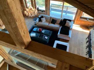Luxurious chalet with stunning wooden beams and large windows offering breathtaking views.