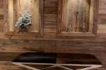 This stunning property boasts a unique wooden wall feature with built-in shelving, adding character and warmth to the space.