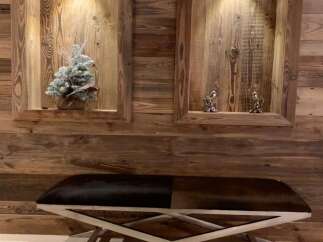 This stunning property boasts a unique wooden wall feature with built-in shelving, adding character and warmth to the space.