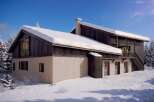 This stunning chalet boasts a unique blend of modern and rustic design, featuring a spacious layout and large windows that offer breathtaking views.