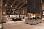 This luxurious chalet boasts a stunning centerpiece: a large, modern fireplace with a rustic stone surround, creating a warm and inviting atmosphere.