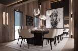 This stunning dining room boasts a large wooden table surrounded by plush, quilted chairs, creating an atmosphere of both luxury and comfort.
