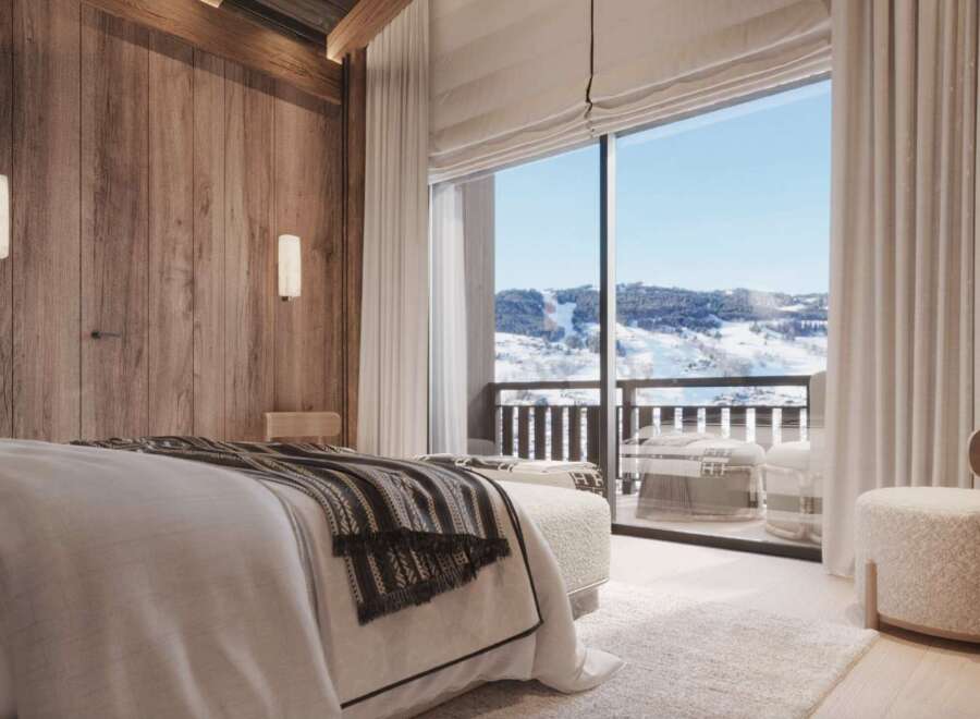 Wake up to breathtaking mountain views from this luxurious bedroom.
