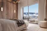 Wake up to breathtaking mountain views from this luxurious bedroom.