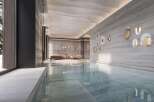 Indulge in the serene ambiance of this luxurious indoor pool, seamlessly blending natural light and sophisticated design.