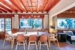 This stunning chalet boasts a spacious dining area with a large wooden table and comfortable seating, perfect for family gatherings.