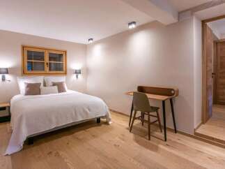 Cozy bedroom with a comfortable bed and a small workspace.