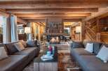This stunning chalet boasts a spacious living area with a cozy fireplace, perfect for relaxing after a day on the slopes.