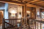 Rustic-chic chalet with exposed wooden beams and a stunning chandelier.
