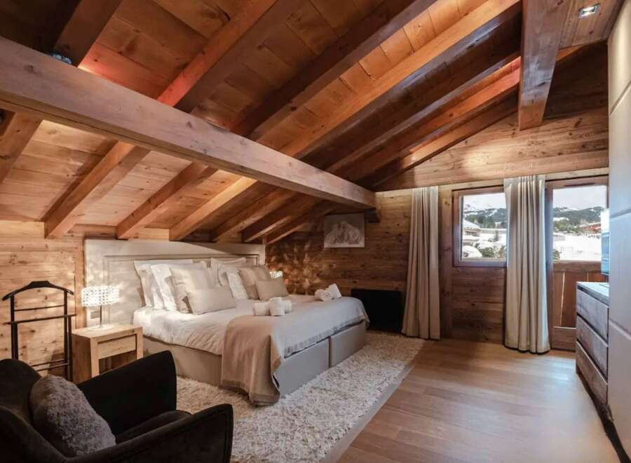 Luxurious chalet bedroom with stunning mountain views.
