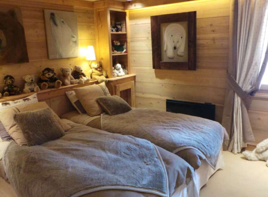 Cozy chalet bedroom with twin beds, perfect for kids.