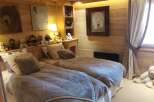 Cozy chalet bedroom with twin beds, perfect for kids.