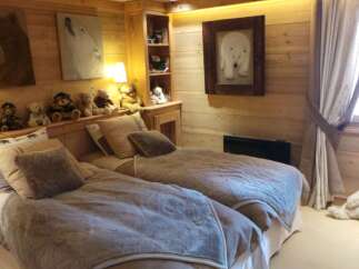 Cozy chalet bedroom with twin beds, perfect for kids.