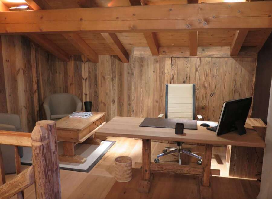 Rustic wooden office space with exposed beams and reclaimed wood walls.