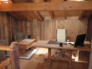 Rustic wooden office space with exposed beams and reclaimed wood walls.