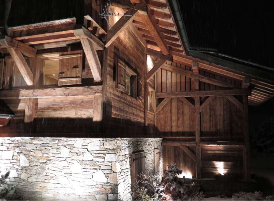 This stunning chalet boasts exquisite exposed timber framing and a rustic stone foundation, creating a warm and inviting atmosphere.