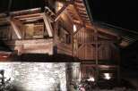 This stunning chalet boasts exquisite exposed timber framing and a rustic stone foundation, creating a warm and inviting atmosphere.