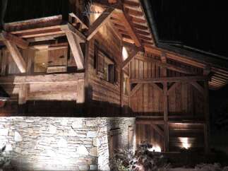 This stunning chalet boasts exquisite exposed timber framing and a rustic stone foundation, creating a warm and inviting atmosphere.