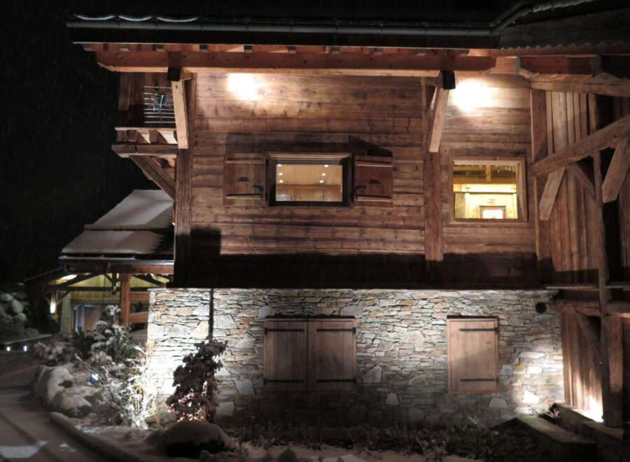 This stunning chalet boasts a rustic-chic exterior with exposed wooden beams and stonework.