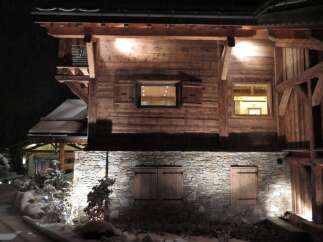This stunning chalet boasts a rustic-chic exterior with exposed wooden beams and stonework.