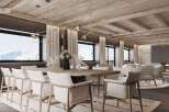 This stunning dining room boasts a large 12-seater table, a designer fireplace, and an exposed beam ceiling.