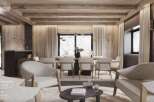 This stunning parlor boasts dark wooden walls, wide-plank parquet flooring, and an exposed beam ceiling, creating a warm and inviting atmosphere.