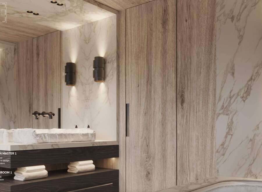 Luxurious master bathroom boasts marble bathtub, wide stone basin, and dark wood cabinetry.