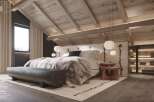This stunning bedroom boasts an exposed wooden framework, integrated lighting, and wide-plank parquet flooring.