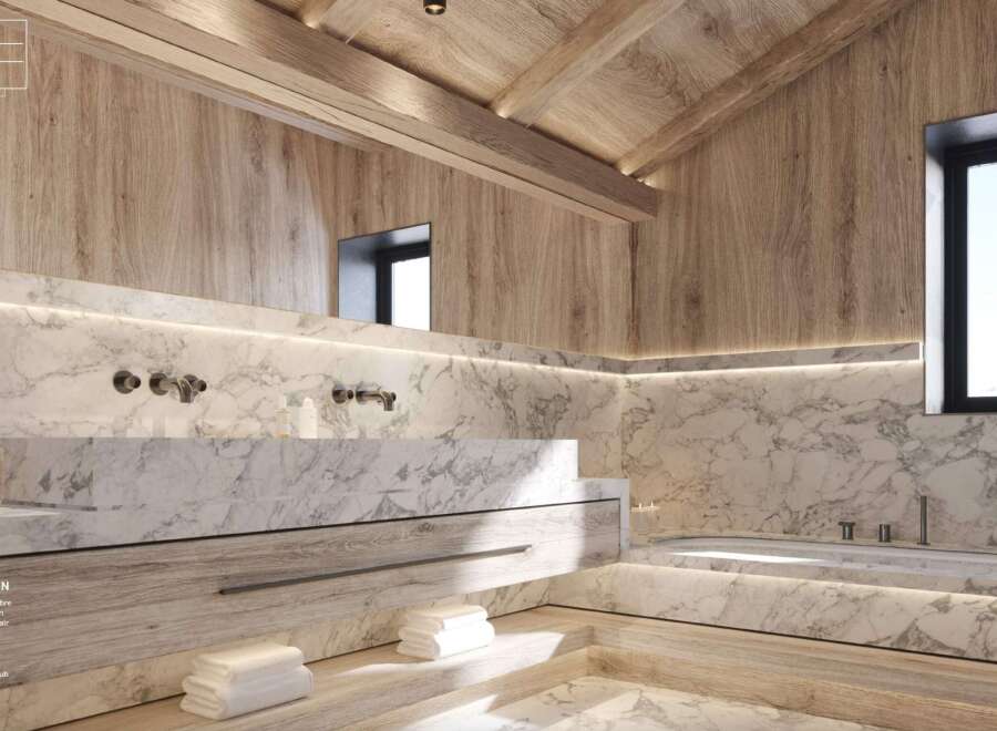 Luxurious bathroom with marble bathtub and basin, light wood cabinetry, and integrated lighting.
