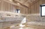 Luxurious bathroom with marble bathtub and basin, light wood cabinetry, and integrated lighting.