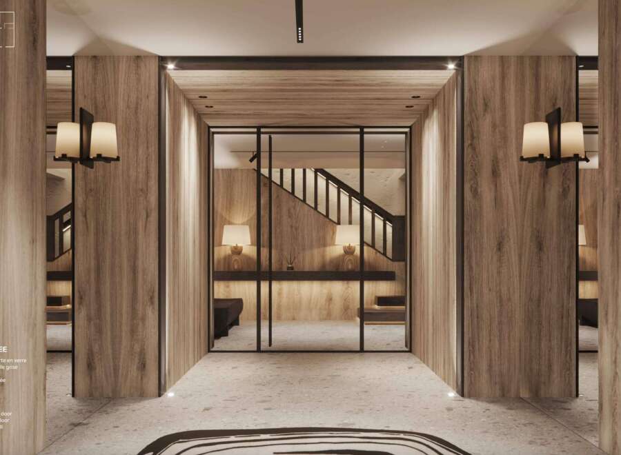 This stunning entry hall boasts a wide glass door, natural grey stone floor, and light-colored wood walls.