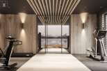 Luxury fitness room with integrated lighting, light wood walls and mirror, and dark wood ceiling.