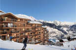 Luxury ski-in/ski-out apartments in the French Alps, offering breathtaking mountain views and direct access to the slopes.