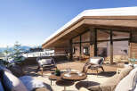 This luxurious chalet boasts a spacious balcony with breathtaking mountain views, perfect for enjoying après-ski drinks or a relaxing morning coffee.