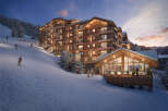 Luxury ski-in/ski-out resort nestled in the French Alps, offering stunning mountain views and direct access to slopes.