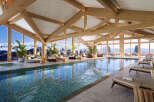 Indulge in luxury at this stunning resort, boasting a breathtaking indoor pool with panoramic mountain views.