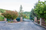 Discover the charm of this gated community entrance, featuring a beautiful teal gate and stone pillars.