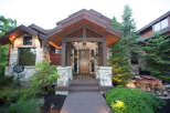 This stunning home boasts a beautiful stone facade and a welcoming wooden front door.